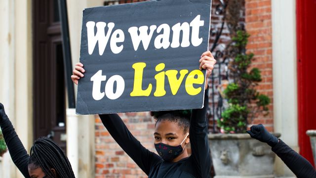Qkidz performing at ArtWorks Time Saved vs. Time Served Mural dedication. Photo by Louis Rideout.