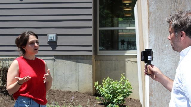 Senior Director of Impact, Sydney Fine, giving press interview.