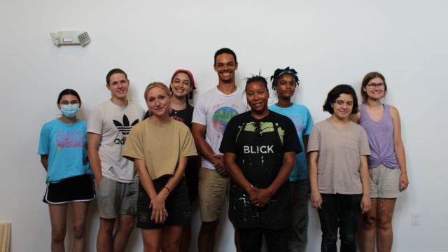 The Way We See Ourselves Gallery Team works with April Sunami. Photo by Sandra Okot-Kotber. The Way We See Ourselves Gallery Team