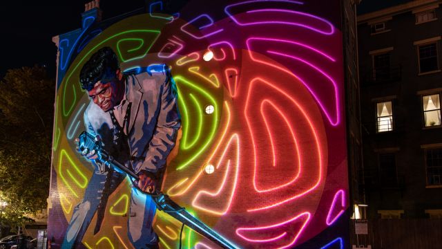 Photo of Kyle Eli Ebersole projection on Mr. Dynamite mural. Photo by J. Miles Wolf.