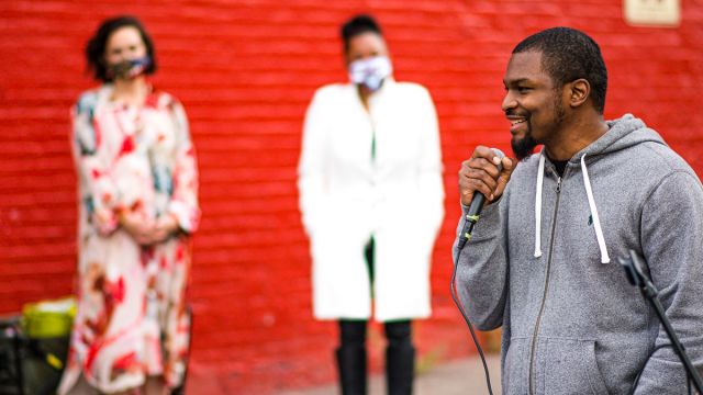 Russell Craig speaking at the ArtWorks Time Saved vs. Time Served Mural dedication. Photo by Louis Rideout.